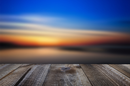 Wooden free space on table and sunset over the seaの写真素材