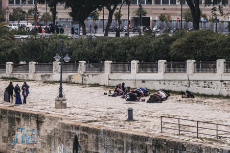 Seville, Spain - December 16, 2016: Muslims praying near the golden tower in Seville, Spain. The Golden Tower was the last major building that the Muslims constructed in Seville. It was built around 1220.のeditorial素材