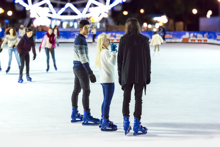 Seville, Spain - December 16, 2016: Teenagers girls and boy skating on ice rink on December 16, 2016 in Seville, Spainのeditorial素材