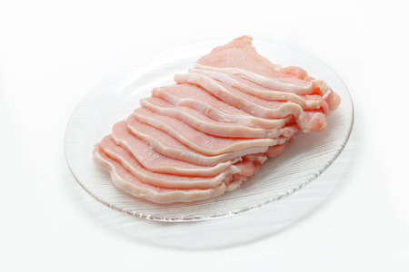 Pork slices on dish isolated in white backgroundの写真素材