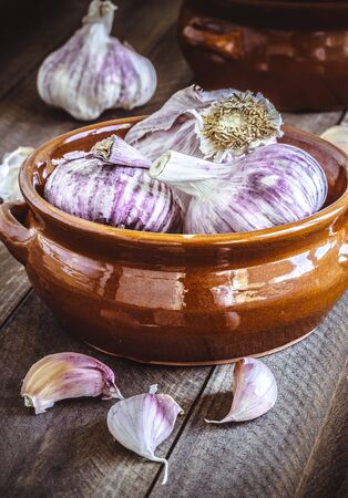 Violet Garlic on wooden vintage background.の写真素材