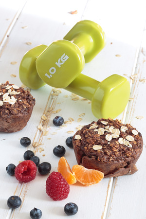 Healthy Oat and apple muffin with fruits and Dumbbells. Diet conceptの写真素材