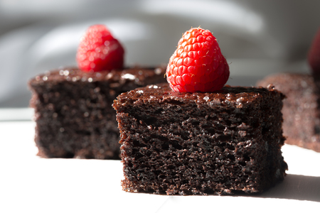 Dark chocolate cake decorated with raspberriesの写真素材