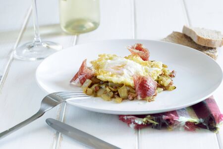 Fried eggs with ham and vegetablesの写真素材