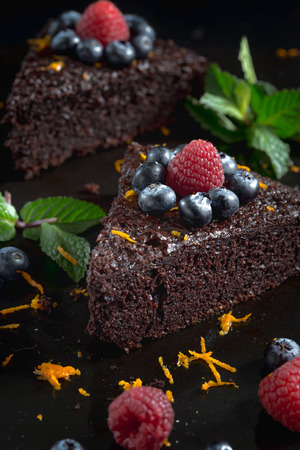 Slices of chocolate cake on black background.の写真素材