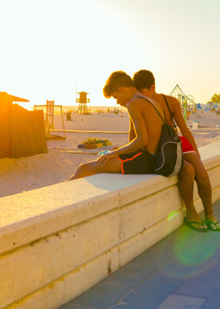 ROTA, SPAIN - SEPTEMBER 09, 2016:  Rota Beach. Young People enjoying the beach at sunset. Rota, Cadizのeditorial素材