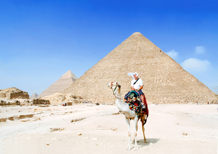 Man tourist riding on camel in Egypt desertの写真素材