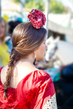Seville, Spain - May 02, 2017: Beautiful woman wearing flamenco dress at the Seville's April Fair.のeditorial素材