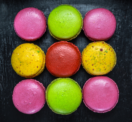 Colorful macaroons. Sweet macarons on dark background .Top view.の写真素材