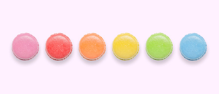 Top view of tasty colorful macaroons on pink background.の写真素材
