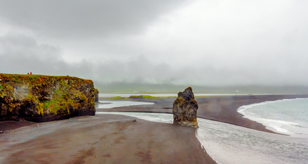 Panorama of Beautiful rock formation on a volcanic sand beach at Cape Dyrholaey. Icelandの写真素材