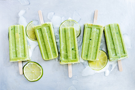 Mojito, yogurt and lime popsicles on ice cubes. Refreshing and Healthy summer dessertの写真素材
