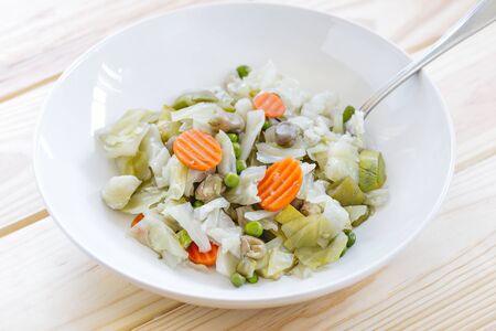 Dish with Mix of cooked vegetables on wooden table. Diet and healthy food concept. Vegetarian foodの写真素材