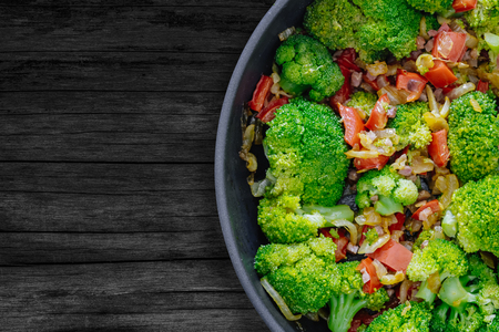 Fresh Summer Salad. Sauteed vegetables, Broccoli and soy sauce with 
diced Iberian Ham on rustic wooden table. Top viewの写真素材