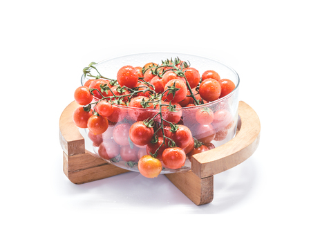 Fresh Cherry tomatoes in glass bowl on white background.の写真素材