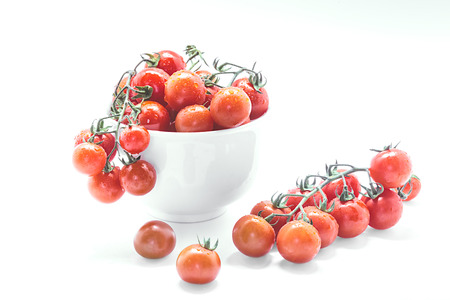 Healthy Cherry tomatoes in glass bowl on white background.の写真素材