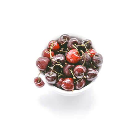 Healthy Cherries in white bowl. Fresh cherries isolated on white background.の写真素材