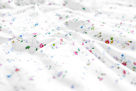 White and floral bed sheets backgroundの写真素材