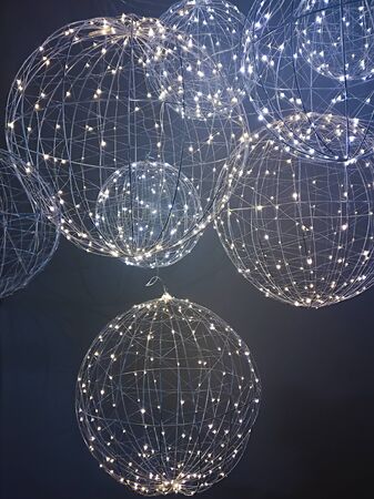 Christmas decoration hanging. Christmas lighs on dark background.の写真素材