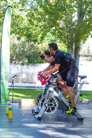 Zamora, Spain - September 02, 2017: Coaches cheering spinning session outdoors in an urban park. Cycle Against Cancer. Organized by the Spanish Association Against Cancer of Zamora. Spain.のeditorial素材
