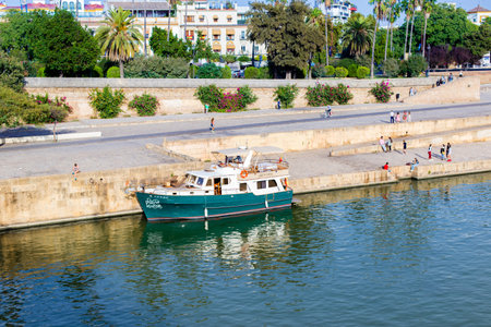 Seville, Spain - October 12, 2017: Guadalquivir River Boat Cruise In Seville. One of the highlights while visiting Seville is going on a river boat cruise on the waters of the Guadalquivir, he only navigable river in Spain.のeditorial素材