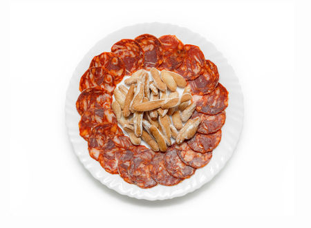 Spanish chorizo sausage. Traditional Iberian Sausage dish (Chorizo Iberico) with breadsticks isolated on white background. Iberian pork meat. Top view.の写真素材