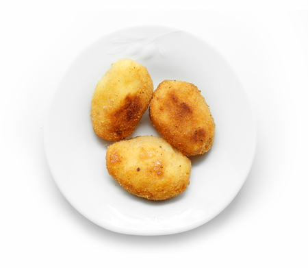 Homemade traditional Spanish croquettes on a white plate and isolated on white background.の写真素材