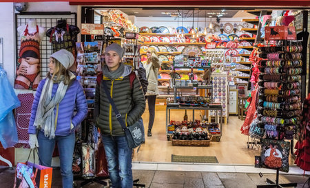 Seville, Spain - January 13, 2018: Young people shopping. People in the sales looking at  store. Twice a year in Spain shoppers are treated to an end-of-season sale period, called las rebajas, in which goods can be purchased at a significant discount.のeditorial素材
