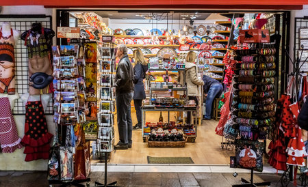Seville, Spain - January 13, 2018: Young people shopping. People in the sales looking at  store. Twice a year in Spain shoppers are treated to an end-of-season sale period, called las rebajas, in which goods can be purchased at a significant discount.のeditorial素材