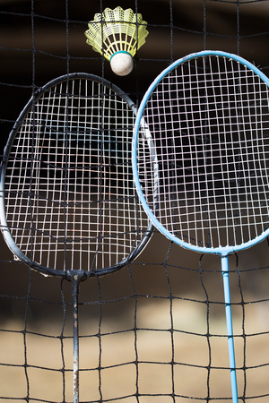 Badminton rackets and shuttlecock with the net  in outdoor field.の写真素材