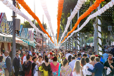 Seville, Spain - May 03, 2017: Crowd of people of all ages having fun at sunset and dressed in traditional costumes at the Seville's April Fair.のeditorial素材