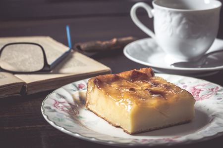 Sweet homemade apple cake and coffee. Breakfast and reading on rustic wooden table.
の写真素材