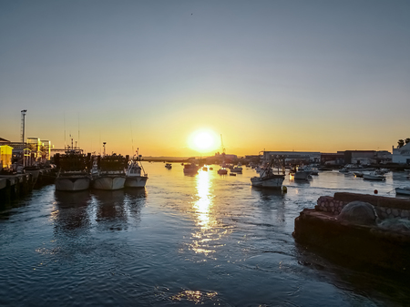 Fishing boats at sunset in Isla Cristina harbour, Huelva, province of Andalusia, Spain.の写真素材