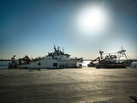 Fishing boats in a Spanish harbor. Front view backlight maritime scene.の写真素材