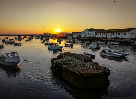 Fishing boats at sunset in Isla Cristina harbour, Huelva, province of Andalusia, Spain.の写真素材