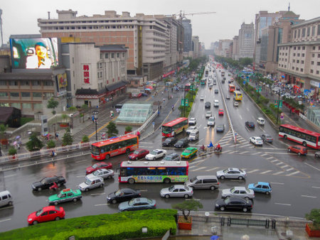 Xian, China - July 09, 2010: Traffic in the city of Xian in a Rainy day . Street scene of xian in the center of ancient city, Chinaのeditorial素材
