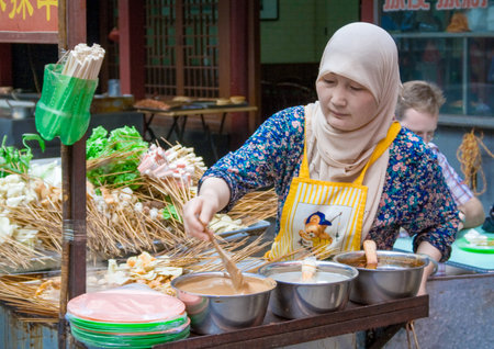 Xian, China - July 12, 2010: Muslim Street in Xian. The main food street area is known as Huimin Street or Muslim Quarter. Hui people are a muslim ethnic minority in Xian. Beiyuanmen Moslem Street, Muslim Quarters, Xian China.のeditorial素材