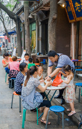 Xian, China - July 12, 2010: Muslim Street in Xian. The main food street area is known as Huimin Street or Muslim Quarter. Hui people are a muslim ethnic minority in Xian. Beiyuanmen Moslem Street, Muslim Quarters, Xian China.のeditorial素材