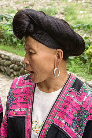 Longji, China - July 15, 2010: Portrait of Red Yao woman. Red Yao women of Huangluo are known for the âworldâs longest hair villageâ. Longsheng Huangluo Yao Village. Guilin, Guangxi, China.のeditorial素材
