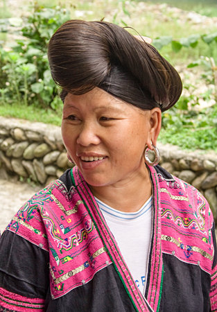 Longji, China - July 15, 2010: Portrait of Red Yao woman. Red Yao women of Huangluo are known for the âworldâs longest hair villageâ. Longsheng Huangluo Yao Village. Guilin, Guangxi, China.のeditorial素材
