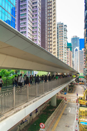 Hong Kong, China - July 20, 2010: Modern office building and People in a pedestrian overpass downtown in Central Hong Kongのeditorial素材