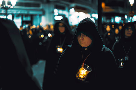 Zamora, Spain - March 31, 2018: Ladies of the Virgin of Solitude during holy week (semana santa) in Zamora, Spain. The ladies wear rigorous mourning, with a black cloak with a cap, with a distinctive medal and with a glass tulip.のeditorial素材