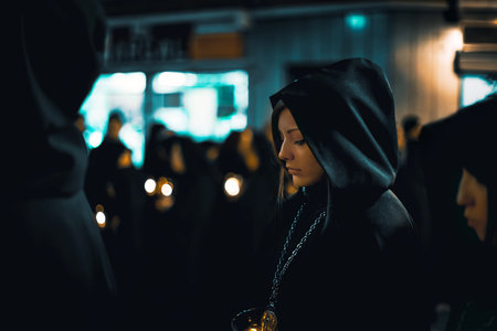 Zamora, Spain - March 31, 2018: Ladies of the Virgin of Solitude during holy week (semana santa) in Zamora, Spain. The ladies wear rigorous mourning, with a black cloak with a cap, with a distinctive medal and with a glass tulip.のeditorial素材