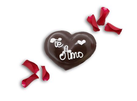 Festive dessert in the shape of a heart with text I love you in Spanish and rose petals isolated on white.の写真素材