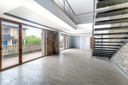 Empty and unfurnished brand new modern house. Beautiful big living room.の写真素材
