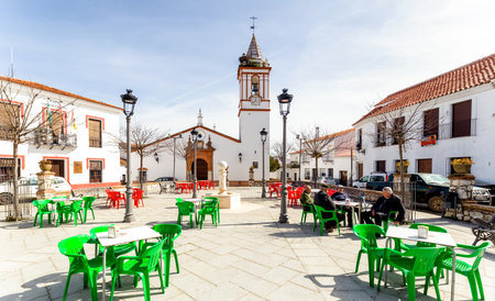Cortelazor, Spain - February 23, 2019: Older men sitting and talking in the town square on a sunny day. The rural exodus has been triggered in Europe since the early decades of the second half of the twentieth century. Many people, especially the younger のeditorial素材