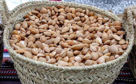 Autumn almonds in basket. Background with autumn almonds. Selective focus. Closeup.の写真素材