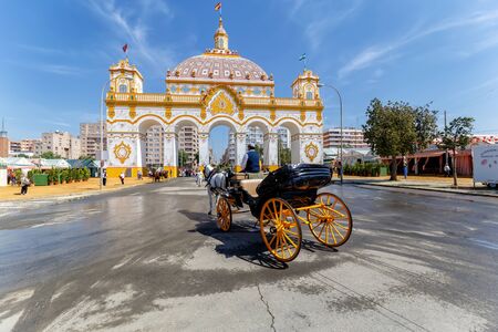 Entrance arch (Portada) and Tipical carriage at the April Fair ((Feria de Abril), Seville Fair (Feria de Sevilla), Andalusia, Spainの写真素材