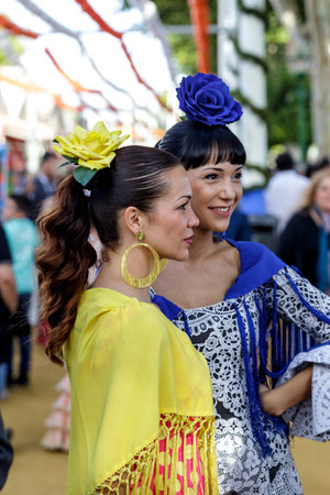 Seville, Spain - May 09, 2019 : Beautiful women wearing flamenco dress at the April Fair (Feria de Abril), Seville Fair (Feria de Sevilla), Andalusia, Spainのeditorial素材