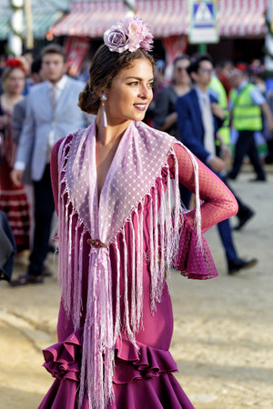 Seville, Spain - May 09, 2019 : Beautiful woman wearing flamenco dress at the April Fair (Feria de Abril), Seville Fair (Feria de Sevilla), Andalusia, Spainのeditorial素材